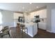 Modern kitchen featuring white cabinets, a large island, stainless steel appliances, and stylish counter seating at 735 Locust Dr, Danville, IN 46122