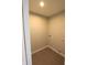 Compact laundry room featuring gray tile flooring, with both electrical and water hookups at 735 Locust Dr, Danville, IN 46122