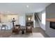 Spacious living room with a fireplace, hardwood floors, and an open floor plan leading to the kitchen at 735 Locust Dr, Danville, IN 46122