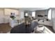 Open-concept living area features a modern kitchen, dining space, and a cozy living room with a fireplace at 735 Locust Dr, Danville, IN 46122