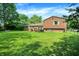 Home's backyard featuring a well-maintained lawn and partial view of the exterior with great natural lighting at 8315 San Marcos Cir, Indianapolis, IN 46256
