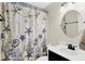A full bathroom with ocean themed decor, including a patterned shower curtain with sea stars and a circular mirror at 8315 San Marcos Cir, Indianapolis, IN 46256
