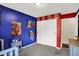 A bright, colorful bedroom with Spiderman decor and a closet with sliding doors at 8315 San Marcos Cir, Indianapolis, IN 46256