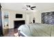 A well-lit bedroom featuring a walk-in closet, television, a dresser and adjacent bathroom with a tiled shower at 8315 San Marcos Cir, Indianapolis, IN 46256