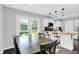 Open dining area with a rustic wood table, seating for six, and french doors leading to the backyard at 8315 San Marcos Cir, Indianapolis, IN 46256