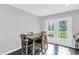 Bright dining area features a wood table, seating for four, and access to the backyard through french doors at 8315 San Marcos Cir, Indianapolis, IN 46256