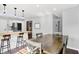 Charming dining room with a rustic wooden table and stylish pendant lighting, open to the modern kitchen at 8315 San Marcos Cir, Indianapolis, IN 46256