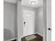 A welcoming entryway features a secure front door with glass pane and a stylish doormat at 8315 San Marcos Cir, Indianapolis, IN 46256
