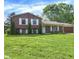 Charming two-story home with a well-manicured lawn and mature trees creating a serene setting at 8315 San Marcos Cir, Indianapolis, IN 46256
