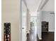 Inviting hallway with wood floors leads to a bright dining area with french doors and backyard view at 8315 San Marcos Cir, Indianapolis, IN 46256