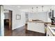 Spacious kitchen featuring butcher block countertops, a view to the dining area and a barn door leading to the living room at 8315 San Marcos Cir, Indianapolis, IN 46256