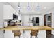 Bright kitchen with white cabinets, butcher block countertops, stainless steel appliances, and modern pendant lighting at 8315 San Marcos Cir, Indianapolis, IN 46256