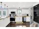 Updated kitchen boasts stainless steel appliances, white cabinets, a butcher block counter, and stylish pendant lights at 8315 San Marcos Cir, Indianapolis, IN 46256