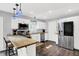 Well-lit kitchen featuring stainless steel appliances, white cabinetry, butcher block island with seating, and hardwood floors at 8315 San Marcos Cir, Indianapolis, IN 46256