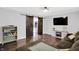 Bright living room featuring wood floors, an entertainment center, and sliding barn doors to the kitchen at 8315 San Marcos Cir, Indianapolis, IN 46256