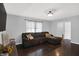 Cozy living room with dark wood floors, a plush sectional sofa, and a view of the backyard at 8315 San Marcos Cir, Indianapolis, IN 46256