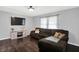 Comfortable living room boasts dark wood floors, a large sectional sofa, and a modern entertainment center at 8315 San Marcos Cir, Indianapolis, IN 46256