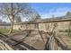 Backyard featuring a tan home exterior, deck, sliding glass door, and mature trees at 8606 Manderley Dr, Indianapolis, IN 46240