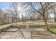 Backyard deck with tree coverage, a wooden fence, and greenery at 8606 Manderley Dr, Indianapolis, IN 46240