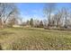 Expansive backyard with a home's tan exterior and surrounding trees at 8606 Manderley Dr, Indianapolis, IN 46240