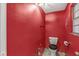 Compact bathroom featuring a toilet and small window at 8606 Manderley Dr, Indianapolis, IN 46240
