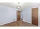 Bedroom featuring hardwood floors and a stylish light fixture at 8606 Manderley Dr, Indianapolis, IN 46240
