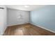 Bedroom with hardwood floors, a window, and blue accent wall at 8606 Manderley Dr, Indianapolis, IN 46240