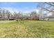 View of the property showcasing the large front yard and exterior details of the single-story home at 8606 Manderley Dr, Indianapolis, IN 46240