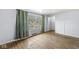 Inviting living room with hardwood floors and a large window offering scenic views at 8606 Manderley Dr, Indianapolis, IN 46240