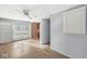 Bright living room featuring a ceiling fan, wood floors, and sliding glass doors at 8606 Manderley Dr, Indianapolis, IN 46240