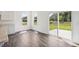 Sunny eating area with wood floors, sliding glass doors to the outside, and bright windows showcasing the outdoors at 8726 Hollander Dr, Camby, IN 46113