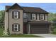 Charming two-story home with a brown exterior, shutters, and a two-car garage at 8726 Hollander Dr, Camby, IN 46113