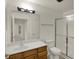 Bathroom featuring a wooden vanity, shower, and a view into another room at 8920 Hunters Creek Dr # 101, Indianapolis, IN 46227