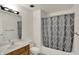 Bathroom featuring a wooden vanity, toilet, shower with curtain, and a mirror at 8920 Hunters Creek Dr # 101, Indianapolis, IN 46227