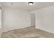 Bedroom featuring neutral carpet, white walls, and multiple doors and closets at 8920 Hunters Creek Dr # 101, Indianapolis, IN 46227