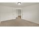 Bedroom featuring neutral carpet, white walls, and an open door that shows another room at 8920 Hunters Creek Dr # 101, Indianapolis, IN 46227