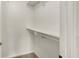 Walk-in closet featuring neutral carpet, white walls, shelving, and a hanging bar at 8920 Hunters Creek Dr # 101, Indianapolis, IN 46227