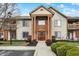 Inviting condominium building entrance with well-maintained landscaping and a welcoming front door at 8920 Hunters Creek Dr # 101, Indianapolis, IN 46227