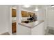 Functional kitchen featuring wood cabinets, stainless steel appliances, and a convenient breakfast bar at 8920 Hunters Creek Dr # 101, Indianapolis, IN 46227