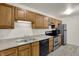 Modern kitchen with wood cabinets, sleek countertops, and stainless-steel appliances at 8920 Hunters Creek Dr # 101, Indianapolis, IN 46227