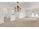Spacious living room with plush carpet and a decorative chandelier above at 8920 Hunters Creek Dr # 101, Indianapolis, IN 46227