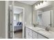 Bathroom featuring double sinks, modern vanity, and a view into bedroom at 950 Edmonds Pl, Greenwood, IN 46143
