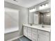 Bright bathroom with double sink vanity, white cabinets, granite countertops, and large mirror at 950 Edmonds Pl, Greenwood, IN 46143