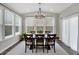 Elegant dining room with large windows, neutral rug, wood table and seating for six at 950 Edmonds Pl, Greenwood, IN 46143