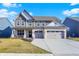 Charming two-story home with a brick facade, gray siding and a spacious two-car garage at 950 Edmonds Pl, Greenwood, IN 46143