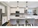 Modern kitchen boasts white cabinets, quartz countertops, stainless steel appliances, and a center island at 950 Edmonds Pl, Greenwood, IN 46143