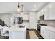 Bright kitchen featuring white cabinets, quartz countertops, stainless steel appliances, and island with bar stools at 950 Edmonds Pl, Greenwood, IN 46143