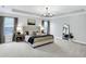 Beautiful bedroom featuring a tray ceiling, neutral walls, and a striking black chandelier at 950 Edmonds Pl, Greenwood, IN 46143