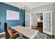 Bright home office with blue accent wall, modern lighting, and white French doors at 950 Edmonds Pl, Greenwood, IN 46143