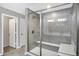 Tiled shower with glass doors features built-in bench and showerhead at 950 Edmonds Pl, Greenwood, IN 46143